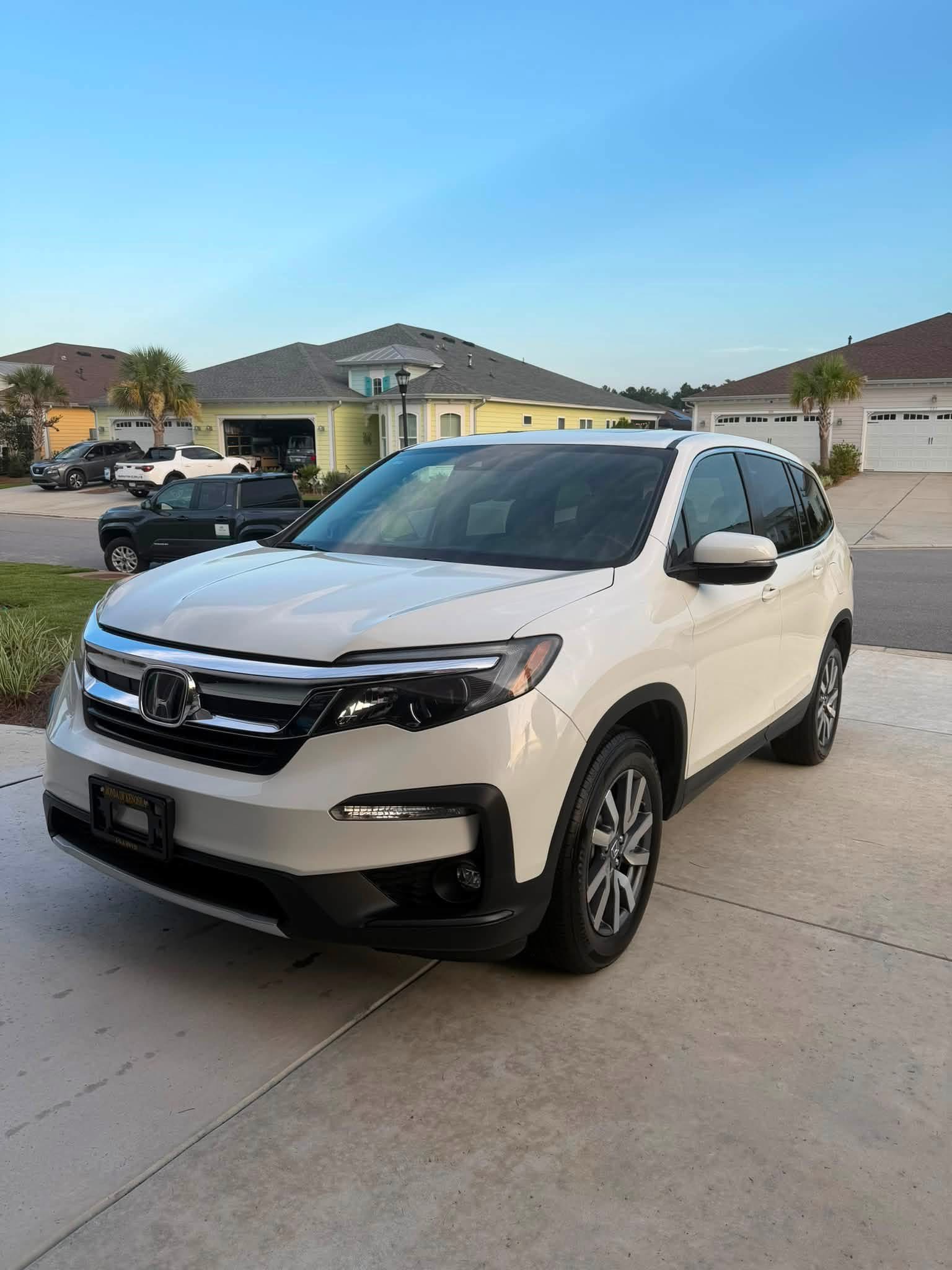 White Honda SUV from KD’s vehicle work, photographed on a residential driveway